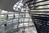 Germany, Berlin, Mitte, Tiergarten, interior of the glass dome on the top of the Reichstag building designed by architect Norman Foster with a double-helix spiral ramp around the mirrored cone that re...