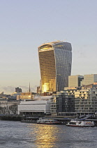 England, London, The Modern skyline of the City with The Walkie Talkie Building with sunlight reflected in the River Thames.