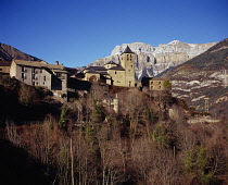 Spain, South Pyrenees, Perched Vill of Torla with the cliffs of Ordesa National Park skyline in mid febuary.