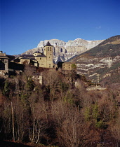 Spain, South Pyrenees, Perched Vill of Torla with the cliffs of Ordesa National Park skyline in mid febuary.