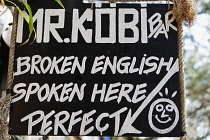 Thailand, Beach bar sign saying Broken English Spoken Here.