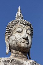 Thailand, Sukothai, Close up of a standing Buddha's head, full of cracks, Wat Trapang Ngoen.