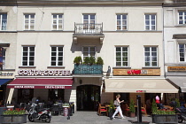 Poland, Warsaw, Nowy Swiat, Exterior of restaurants with tables outside.