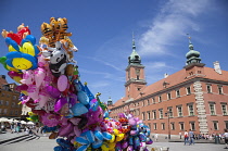 Poland, Warsaw, Old Town, Plac Zamkowy, Arkady Kubickiego, Red Brick Royal Castle with balloon vendor in the foreground.