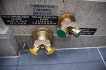 USA, New York State, New York City, Manhattan, Typical sprinkler valves on exterior of building in the financial district.