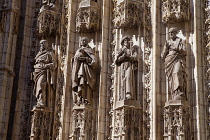 Spain, Andalucia, Seville, Carved figures on the Cathedral Door of the Assumption.