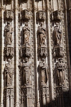 Spain, Andalucia, Seville, Carved figures on the Cathedral Door of the Assumption.