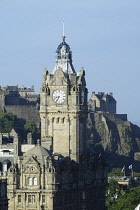 Scotland, Edinburgh, Calton Hill, clock tower on the Balmoral Hotel with Edinburgh Castle in background from Calton Hill.