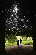 Scotland, Edinburgh, Malleny Garden, children walking through the Yews.