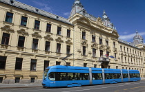 Croatia, Zagreb, Old town, Mihanoviceva Street, Hz Vuca Vlakova national railway headquarters with tram apssing by.