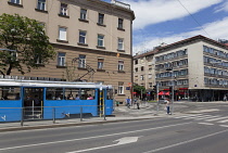 Croatia, Zagreb, Old town, Pedestriasn crossing road with tram waiting.