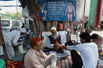 India, Delhi, Road-side medical practitioner in the old quarter of Delhi.