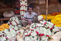 India, Bengal, Kolkata, Garland vendor in Malik Ghat Flower Market, Kolkata.