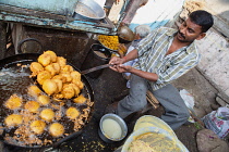 India, Maharashtra, Dhule, Frying kachori at a street food stall in Dhule.