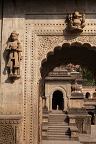 India, Madhya Pradesh, Maheshwar, Statues and carvings on a doorway at the Ahilya Fort in Maheshwar.