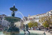 Portugal, Estremadura, Lisbon, Baixa, Praca Rossio with fountain and Statue of King Pedro IV in the centre of the square.