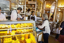 Portugal, Estremadura, Lisbon, Baixa district, Interior of Confeitaraia Nacional shop with tourists buying cakes.