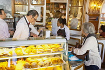 Portugal, Estremadura, Lisbon, Baixa district, Interior of Confeitaraia Nacional shop with tourists buying cakes.