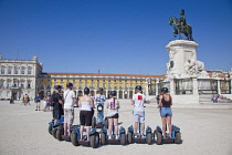 Portugal, Estremadura, Lisbon, Baixa, Praca do Comercio, Segway guided tour of the square with equestrian statue of King Jose and Rua Augusta triumphal arch.