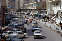 Qatar, Doha, Busy traffic in street with shops.