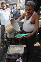 India, New Delhi, Chai vendor in the old city of Delhi.