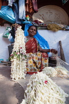 India, West Bengal, Kolkata, A vendor at Malik Ghat flower market.