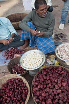 India, Bihar, Gaya, Vendor selling water chestnuts.