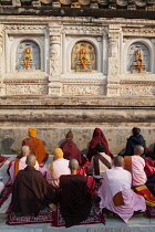 India, Bihar, Bodhgaya, Pilgrims pray at the Mahabodhi Temple at Bodh.