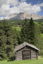 Italy, Trentino Alto Adige, Badia Valley view with wooden farm building, St Leonard.