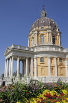 Italy, Piedmont, Turin, Basilica Superga with flowering garden in foreground.