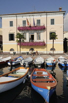 Italy, Veneto, Lake Garda, Bardolino, harbour front with fishing boats.