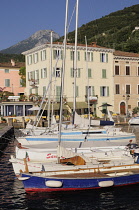 Italy, Lombardy, Lake Garda, Gargnano, harbour with boats & waterfront.