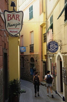 Italy, Liguria, Cinque Terre, Corniglia, narrow street with cafes.