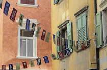 Italy, Trentino, Alto Adige, Trento, Colourful buildings with flags.