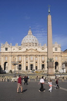 Italy, Lazio, Rome, Vatican City, St Peter's Square, family group walking across the square.