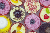 Studio shot of various colouful and decorated cup cakes.