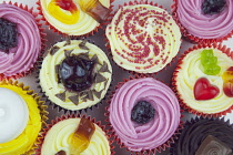 Studio shot of various colouful and decorated cup cakes.