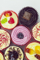 Studio shot of various colouful and decorated cup cakes.