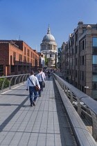 England, London, City workers crossing the Millennium Bridge towards St Paul's Cathedral.