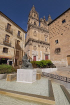 Spain, Castile and Leon, Salamanca, the monument to Spanish music theorist and organist Francisco de Salinas with La Clerecía Church and Casa de las Conchas behind.