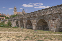 Spain, Castile and Leon, Salamanca, The Roman Bridge of Salamanca with Salamanca Cathedral behind.