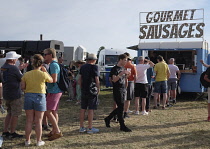 England, Surrey, Guildford, Guilfest, Queue of festival goers at fast food stall.