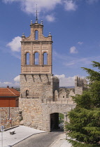 Spain, Castile and Leon, Avila, City walls with the brick steeple of the former Carmelite convent El Carmen above the Puerta del Carmen viewed from the walkway along the top perimeter of the walls.