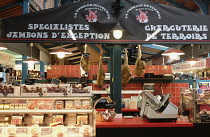 France, Pays Basque, St Jean de Luz indoor market. Charcuterie shop specialising in ham, sausage and bacon.