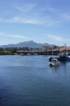 France, Pays Basque, St Jean de Luz harbour and River Nivelle looking towards La Rhune mountain.