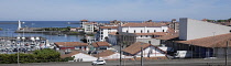 France, Pays Basque, St Jean de Luz harbour from the neighbouring town of Cibourne showing the harbour, fishing boats and lighthouse, sea, maritime cooperative, blue sky, blue sea.