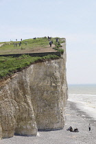 England, East Sussex, Birling Gap, View passed costguard cottages showing chalk cliffs and pebble beach.