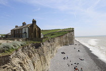 England, East Sussex, Birling Gap, View passed costguard cottages showing chalk cliffs and pebble beach.