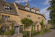 England, Gloucestershire, Cotswolds, Lower Slaughter, typical golden Cotswold streetscape in evening light.