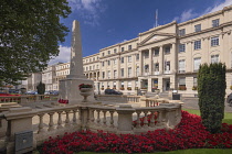 England, Gloucestershire, Cheltenham, The Promenade, Municipal Offices and Gardens dating from 1840 with World War One memorial in the foreground erected in 1921 and restored in 2016.